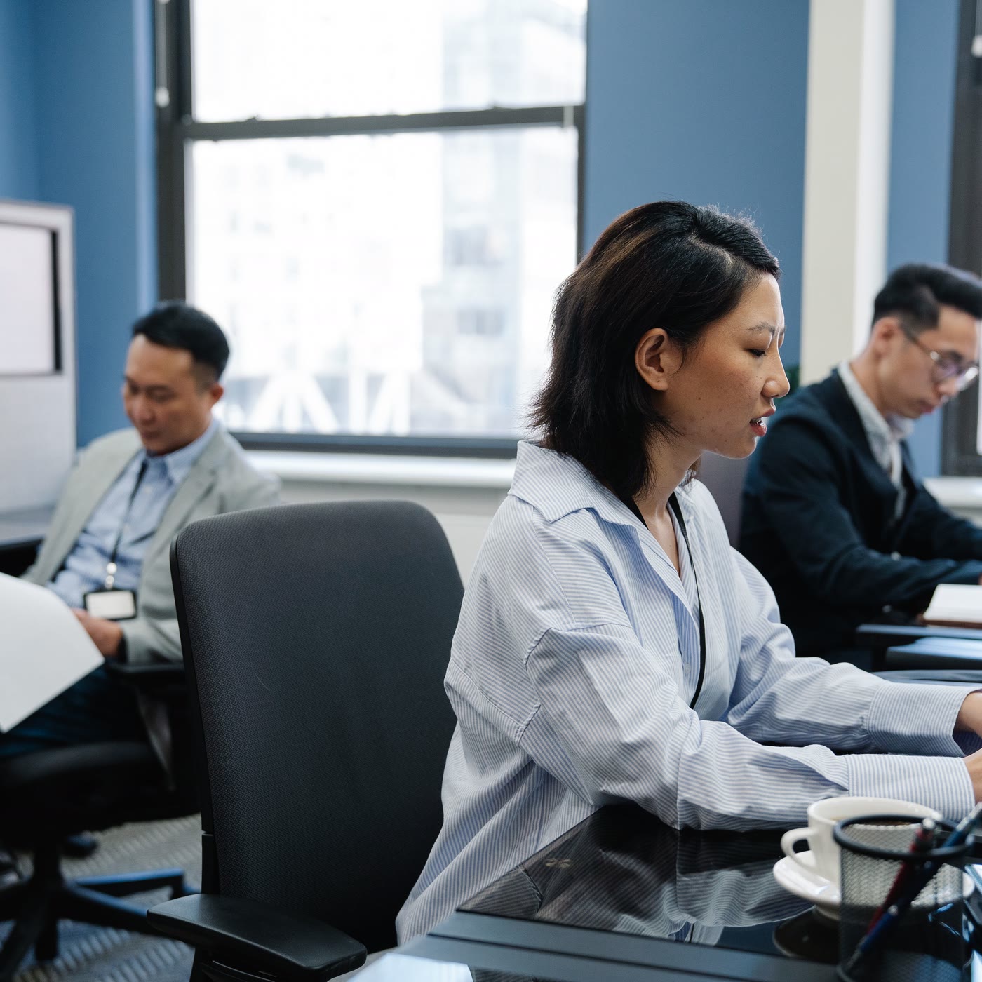 Asian technology professionals working in a modern office.